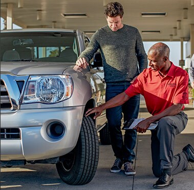  Service technician putting on a new Toyota tire.